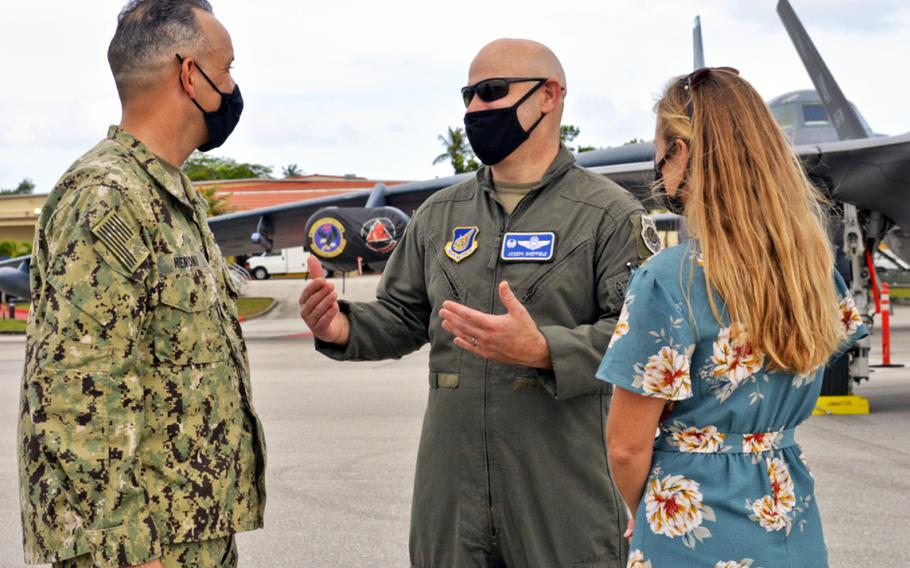 In a Feb. 13, 2021 photo, U.S. Navy Rear Adm. John Menoni, Joint Region Marianas commander, left, speaks with U.S. Air Force Col. Joseph Sheffield, 36th Operations Group commander, and his spouse, Sarah Sheffield, during an Exercise Cope North aircraft static display at Andersen Air Force Base, Guam.