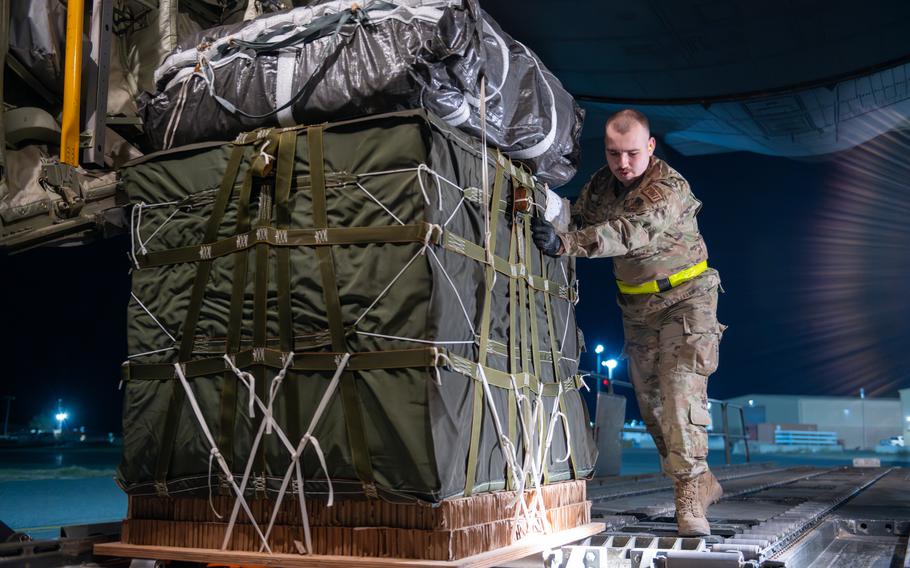 A U.S. Air Force Aerial Port Airman aboard a C-130J Super Hercules in the U.S. Central Command area of responsibility loads a pallet of food destined for an airdrop over Gaza, Tuesday, March 5, 2024. 