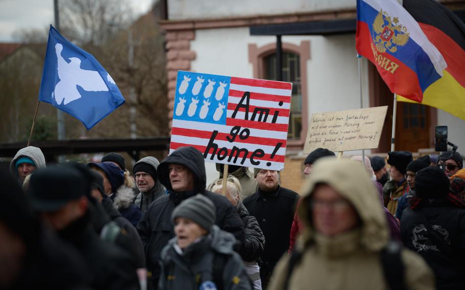 A hand-painted sign calls for U.S. forces to go home during a protest march in downtown Ramstein-Miesebach, Germany, on Feb. 26, 2023. "Ami" is a German abbreviated term for "American," often used in a derogatory way.