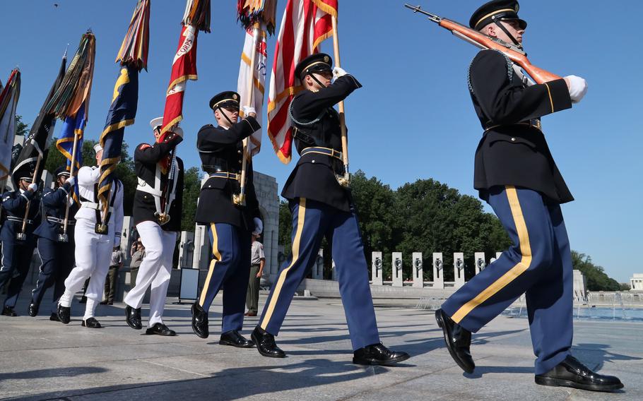 The Armed Forces Color Guard from the Military District of Washington marches into a Memorial Day ceremony at the National World War II Memorial in Washington, May 30, 2022.