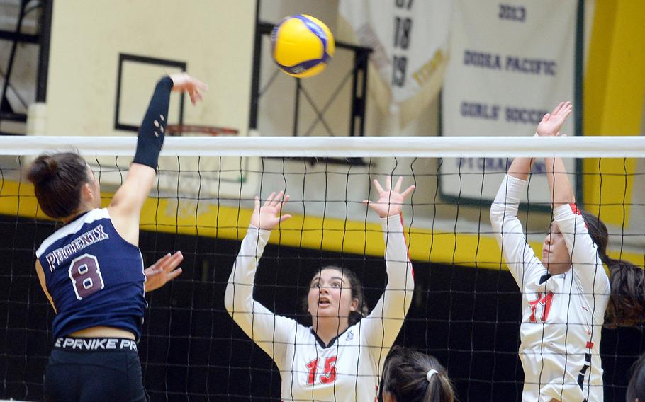 Seisen's Lisa Purcell spikes over E.J. King's MacKinzi Dudley and Maliwan Schinker during Friday's pool play in the 8th American School In Japan YUJO volleyball tournament. The Phoenix won in three sets.