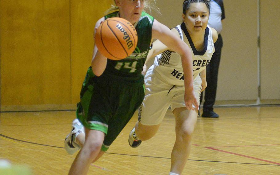 Kubasaki's Bella Clark drives upcourt against International School of the Sacred Heart during Friday's 5th American School In Japan Kanto Classic knockout-round game. The Symbas won 33-27 in extra time.