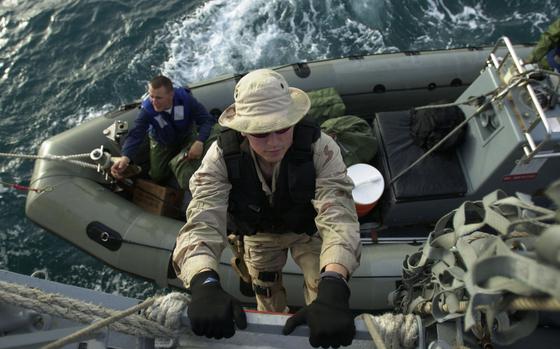 Aboard the USS Milius, Feb. 20, 2003: Navy Petty Officer 2nd Class Chris Gentleman climbs a rope ladder from a rigid-hulled inflatable boat to USS Milius after running maritime interception operations in the Persian Gulf.  Coalition forces are stopping Iraqi smugglers to enforce U.N. sanctions.


Read about the mission and see additional photos here. 
https://www.stripes.com/news/pulling-double-duty-in-iraqi-water-1.2461

META TAGS: Pacific; U.S. Navy; Persian Gulf; USS Milius; War on Terror; Iraq
