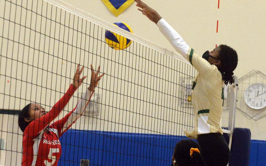 Nile C. Kinnick's Angelica Rodgers has her shot blocked by Robert D. Edgren's Elizabeth Johnson during Saturday's Japan girls volleyball match. The Eagles won in straight sets to improve to 10-0 on the season without dropping a set.