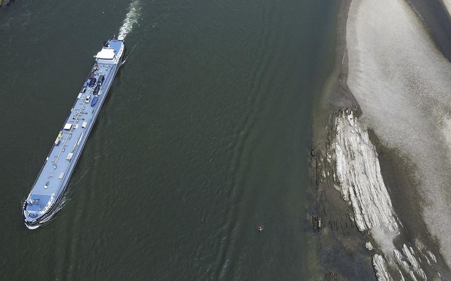 Oil tanker Calcit 12 sails past dry banks on the Rhine River near Oberwesel, Germany, on July 14, 2022. 