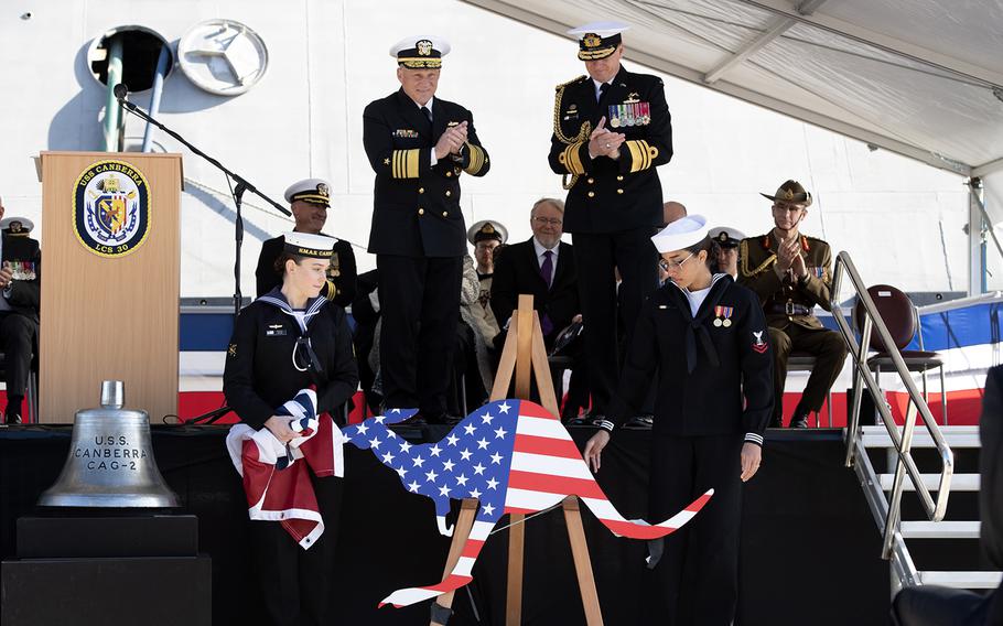 U.S. and Australian sailors unveil a kangaroo-shaped funnel emblem that will adorn the U.S. Navy's newest Independence-variant littoral combat ship, the USS Canberra, during the ship’s commissioning ceremony in Sydney, Australia, July 22, 2023.