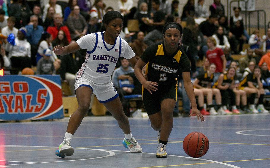 Stuttgart's Macayla Hines dribbles as Ramstein's Brayln Jones defends during a basketball game on Dec. 8, 2023, at Ramstein High School on Ramstein Air Base, Germany.