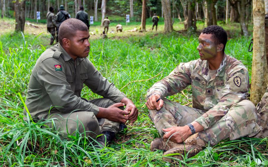 Fiji army Pvt. Tevita Vakataua, left, chats with U.S. Army Spc. Justin Fruiht during training in Labasa, Fiji, July 31, 2019. 
