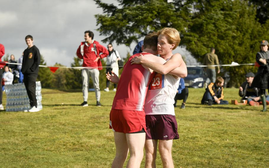 Vilseck senior Jackson Cochran (right) hugs Kaiserslautern junior Jacob Porter at the finish line of the last DODEA-Europe cross country meet of the season Oct. 21, 2023, in Baumholder, Germany. Porter said he was exhausted and also happy to have finished the season.