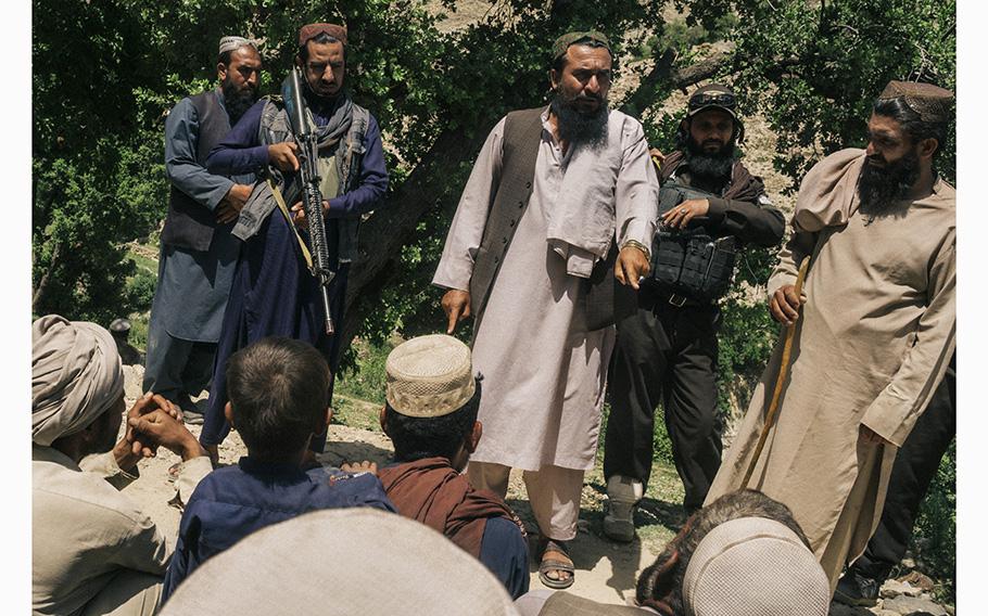 Taliban official Delawar Torkhan lectures farmers in the village of Baghdara against poppy production.