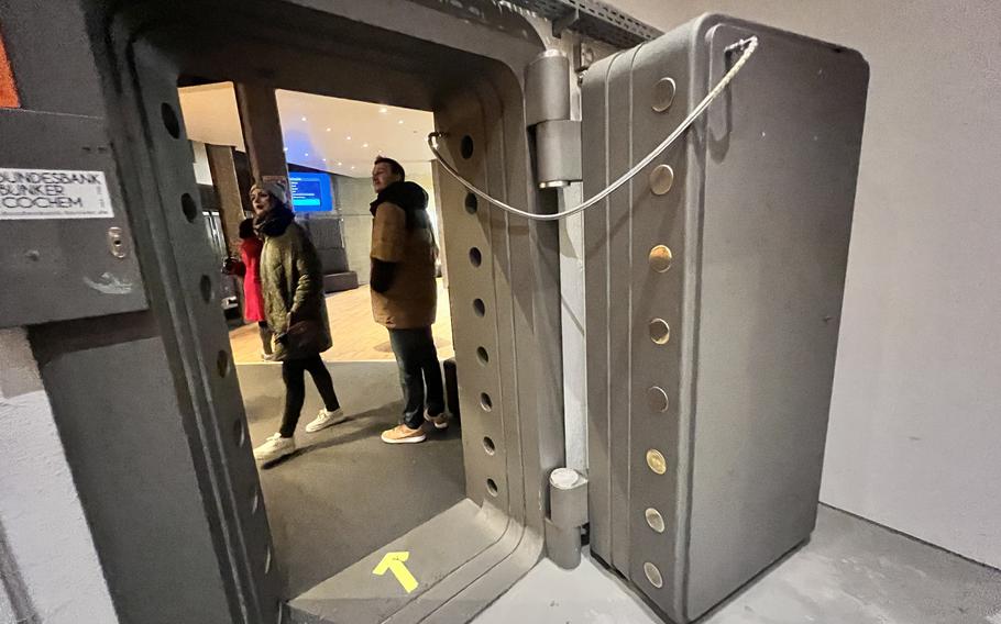 Visitors exit the vault room at the former federal bank bunker March 4, 2023, in Cochem, Germany. The heavy steel-reinforced doors once shielded 15 billion German marks of replacement currency from theft, natural disaster and nuclear attack.