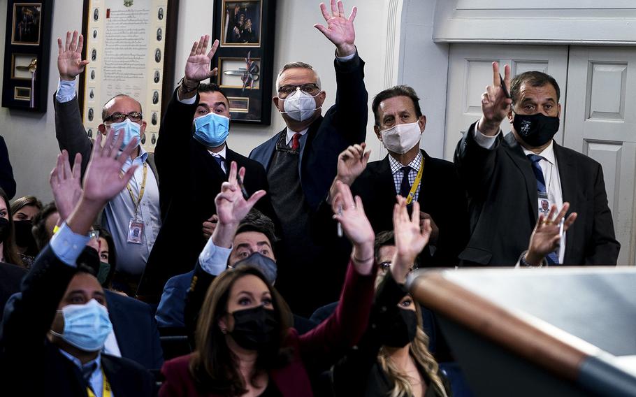 Reporters raise their hands to be called on from National Security Advisor of the United States Jake Sullivan during the daily press briefing at the White House on December 7, 2021. 