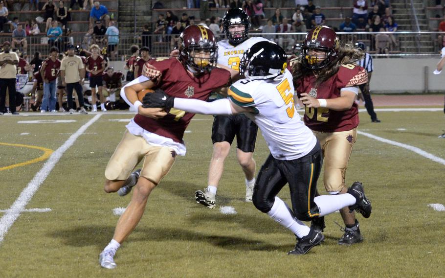 Edgren defender Cayden Ball tries to strip the ball from Perry quarterback Jordan Burford.