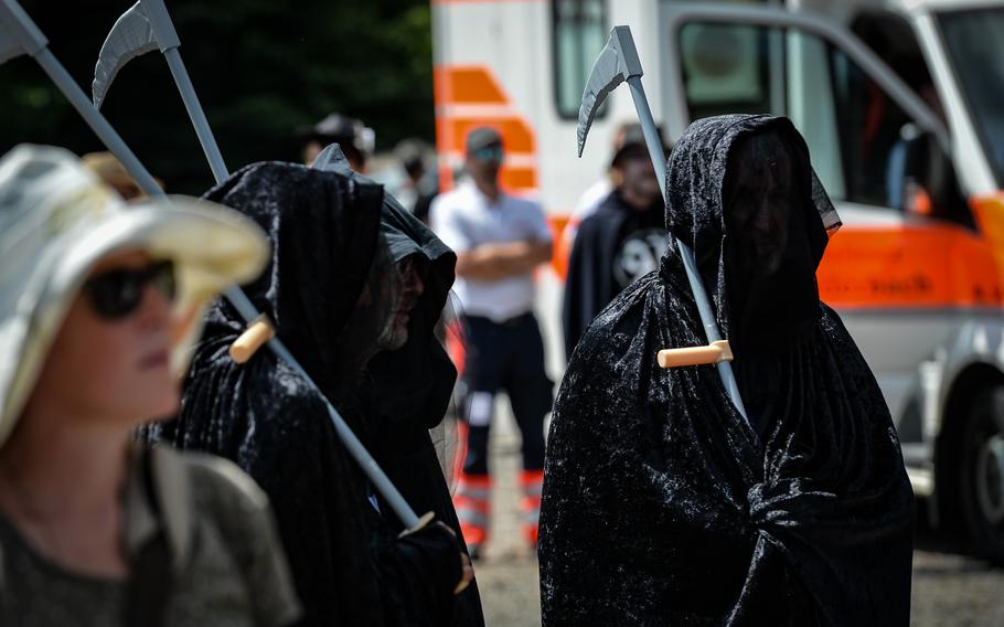 Anti-war activists are cloaked in costumes to protest against war and military activity in Ramstein-Miesenbach, Germany, June 25, 2022. The event’s theme was the “dance for the dead.” 