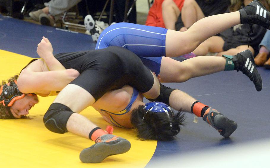 Kadena’s Kurt Chapman gets the upper hand on St. Mary’s Jo Inoue at 160 pounds during Tuesday’s Azabu Ward year-end international open wrestling tournament. Chapman, a 2020 Far East tournament champion, pinned Inoue in 2 minutes, 11 seconds to win the weight-class title.