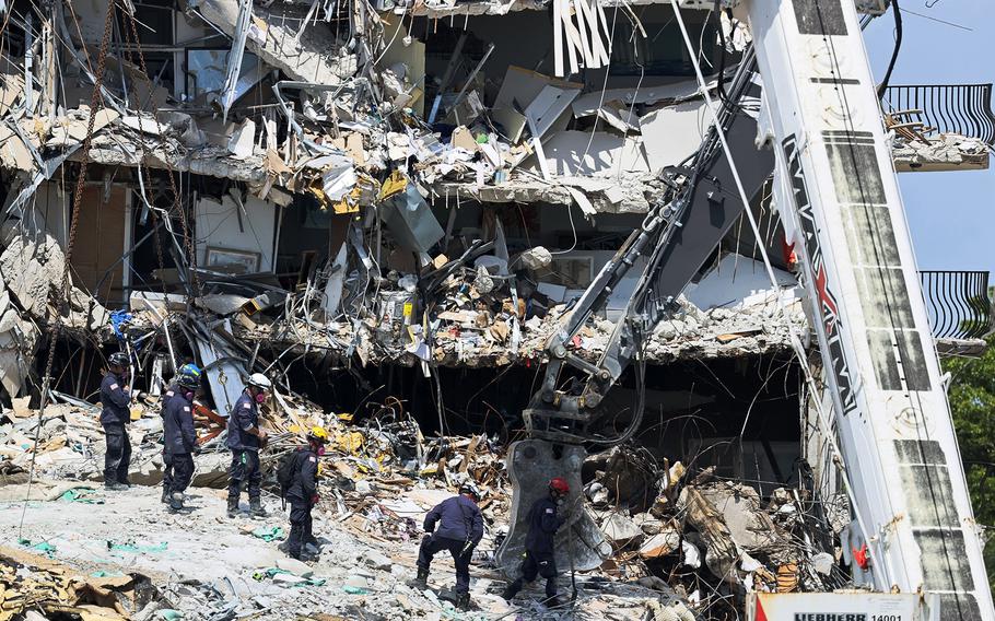 Search and rescue personnel search for survivors through the rubble at the Champlain Towers South Condo in Surfside, Florida, on June 27, 2021. 