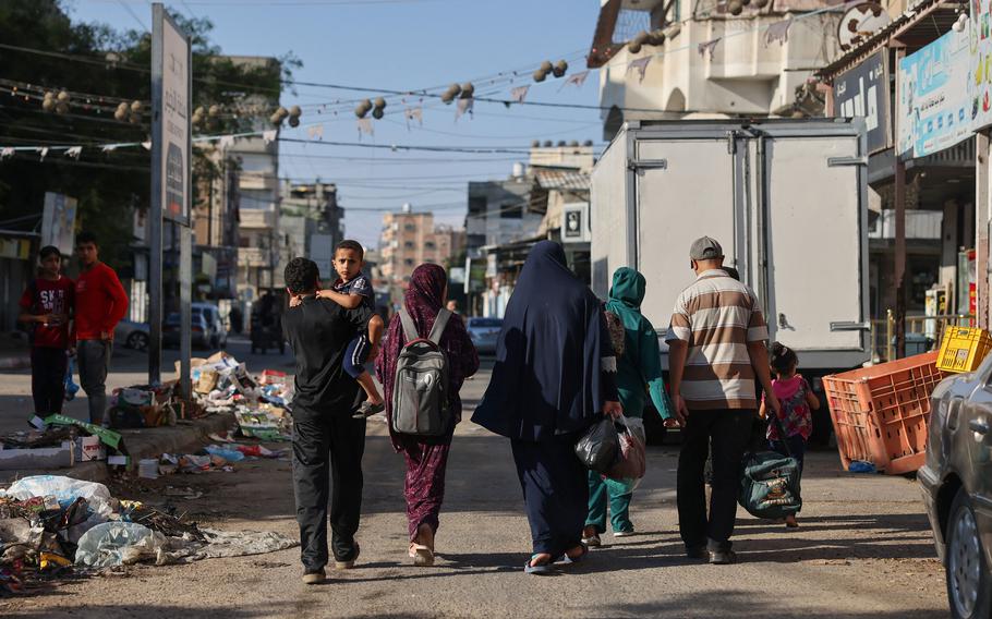 Palestinians carry belongings as they leave their home to a safer place after an Israeli airstrike in Rafah in the southern Gaza Strip on Oct. 18, 2023. Huge numbers of residents of northern Gaza have amassed in the south of the Strip — where the Rafah crossing is located — after Israel warned them to evacuate ahead of an expected ground invasion in retaliation for Hamas’s October 7 attack. 