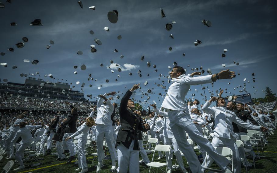 Newly comissioned U.S. Marine Corps second lieutenants and U.S. Navy ensigns toss their covers in celebration at the conclusion of the U.S. Naval Academy’s Class of 2023 graduation ceremony at Navy-Marine Corps Stadium, Annapolis, Md., May 26, 2023. Cadets and midshipmen at the Pentagon’s three military academies can now officially stay enrolled and remain on track for a military career if they give birth to a child under a new policy published this month.