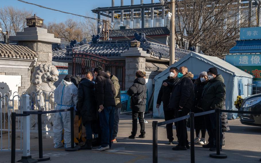 People wait outside a crematorium in Beijing on Dec. 19, 2022.