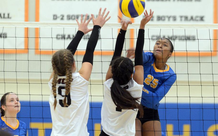 Yokota's Trinity Stegall hits over the double block of Matthew C. Perry's Presley Valez and EllaMhay Dizon during Saturday's DODEA-Japan volleyball match. The Panthers won in four sets.