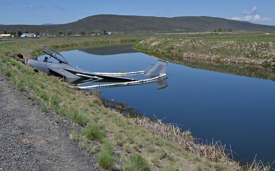 An F-15D Eagle assigned to the 173rd Fighter Wing sits in an irrigation canal following a mishap landing at Kingsley Field in Klamath Falls, Ore., May 15, 2023. 
