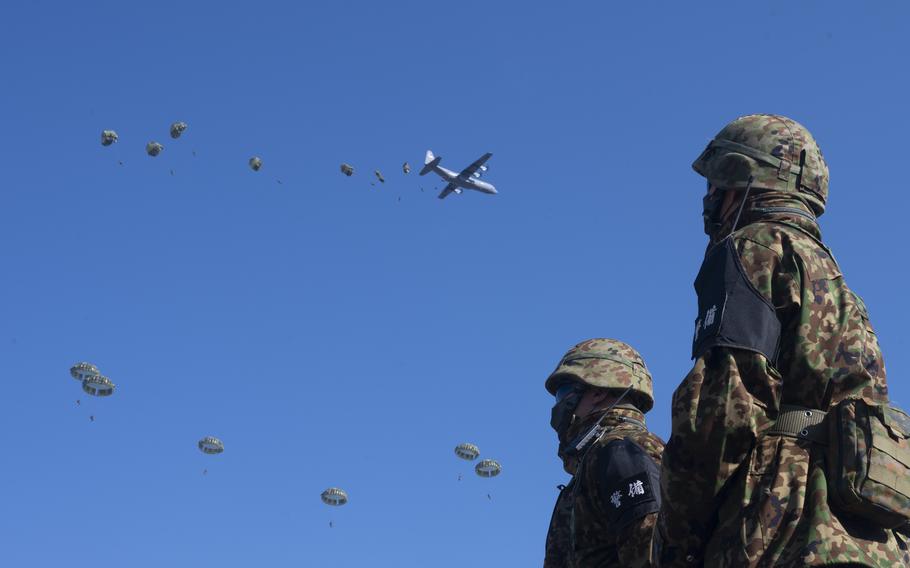 Japan Ground Self-Defense Force paratroopers from the 1st Airborne Brigade, jump out of a U.S. Air Force C-130J Super Hercules assigned to the 36th Airlift Squadron during the annual New Year's jump at Camp Narashino, Chiba, Japan, on Jan. 8, 2023. Approximately 200 paratroopers jumped out of several aircraft in a multilateral collaboration of U.S. Air Force, U.S. Army, British army, Australian army, and Japan Ground Self-Defense Force members.