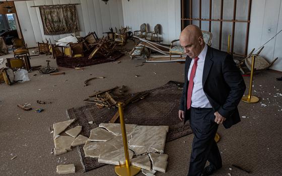 Supreme Court justice Alexandre de Moraes assesses the destruction of the court building in Brasília after the Jan. 8 riot. MUST CREDIT: Photo for The Washington Post by Rafael Vilela