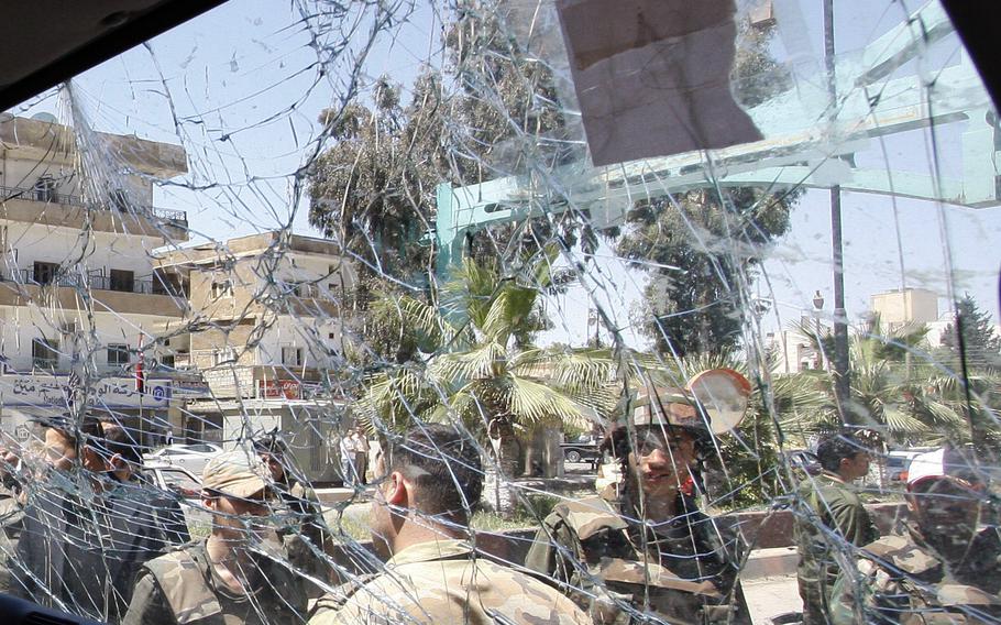 Syrian army soldiers, are seen through a damaged military truck window in Daraa city, Syria, on May 9, 2012. According to reports on Wednesday, Sept. 8, 2021, Syrian forces entered Daraa as part of a truce negotiated by Russia to end fighting in the city.