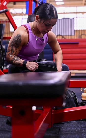 Senior Airman Bianca Mendoza, 377th Security Forces Group defender, reaches into a gym bag at Kirtland Air Force Base, N.M., Dec. 15, 2023.