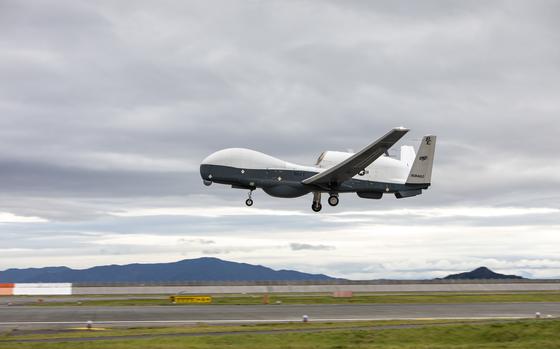 A U.S. Navy MQ-4C Triton takes off from an airfield.