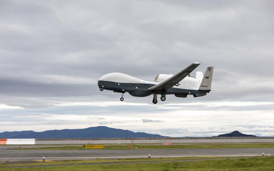 A U.S. Navy MQ-4C Triton takes off from an airfield.
