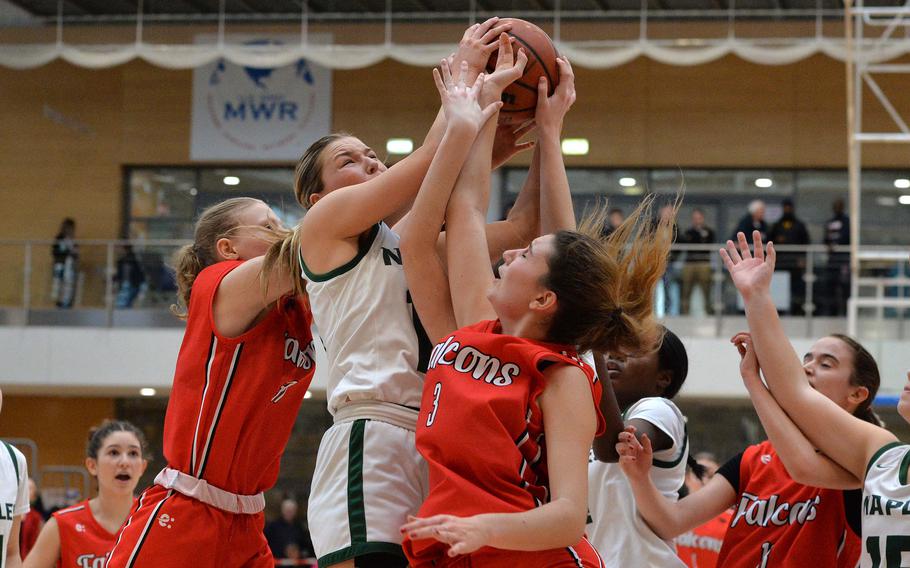 AOSR’s Charlotte Burges-Sims, left, and Nina Neroni fight Naples’ Gracie Grannis for a rebound in the girls Division II final at the DODEA-Europe basketball championships in Wiesbaden, Germany, Feb. 17, 2024. Naples captured the division title with a 48-29 victory.