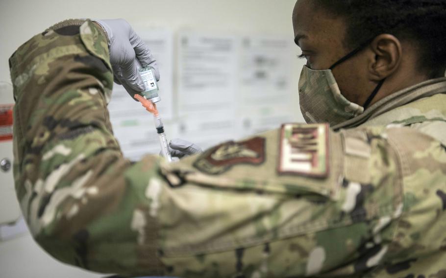 Tech. Sgt. Alexisa Humphre of the 8th Medical Group prepares to inject a dose of the Moderna coronavirus vaccine at Kunsan Air Base, South Korea, Dec. 29, 2020. 
