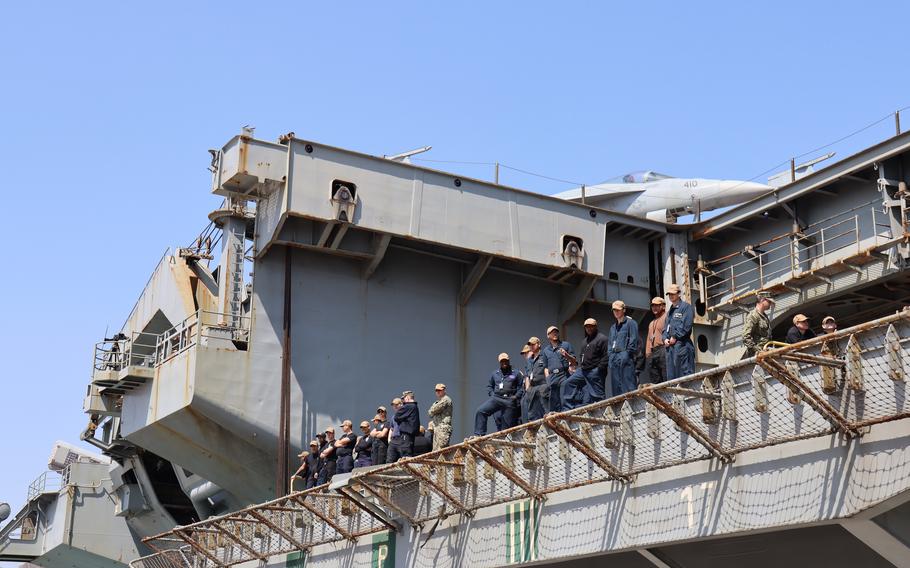 U.S. sailors aboard the USS Nimitz inspect the dock at  Busan, South Korea, March 28, 2023.