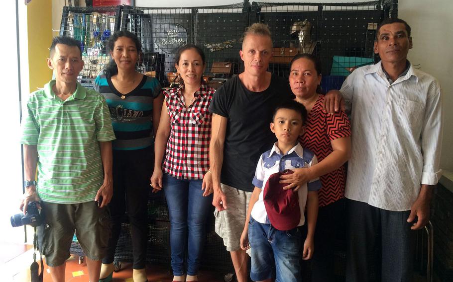 Brian Hjort, center, poses in this undated photo with a family he reunited in Vietnam. Since the early 1990s, Hjort has been using DNA analysis programs and databases to help people find their long-lost relatives. 