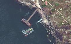 This satellite image provided by Maxar Technologies shows a closer view of barge, serna class landing craft and sunken serna craft near Snake Island in the Black Sea Thursday, May 12, 2022. (Satellite image ©2022 Maxar Technologies via AP)
