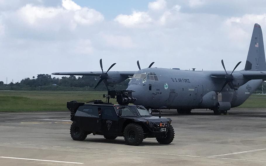 An Indonesian tactical vehicle passes a C-130J Super Hercules assigned to the 36th Airlift Squadron at Sultan Mahmud Badaruddin II International Airport, Palembang, Indonesia, Aug. 10, 2022.