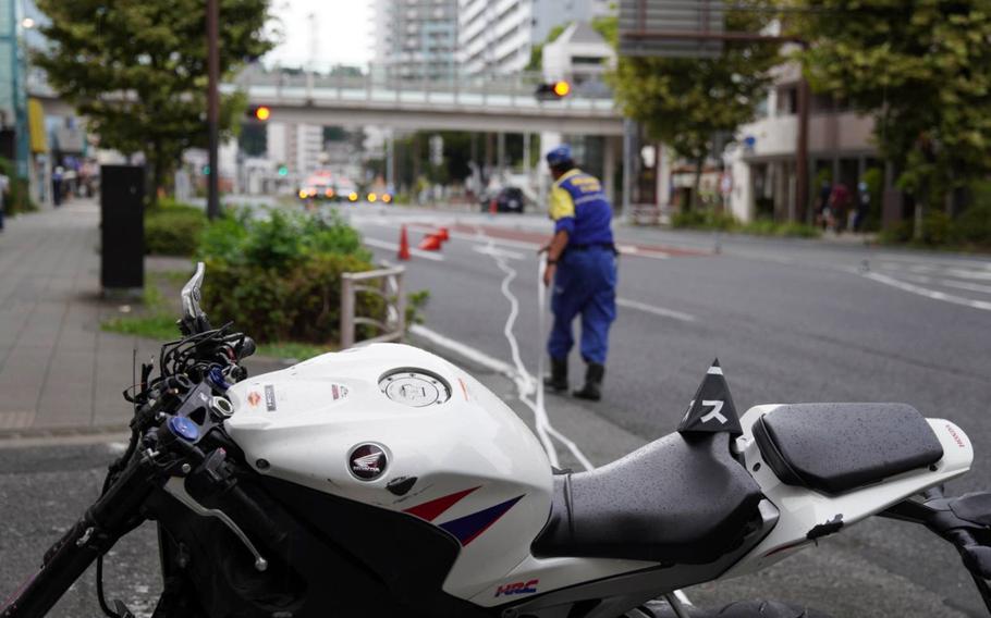 Japanese police investigate a deadly collision just outside the main gate for Yokosuka Naval Base, Japan, Wednesday, Sept. 6, 2023. 