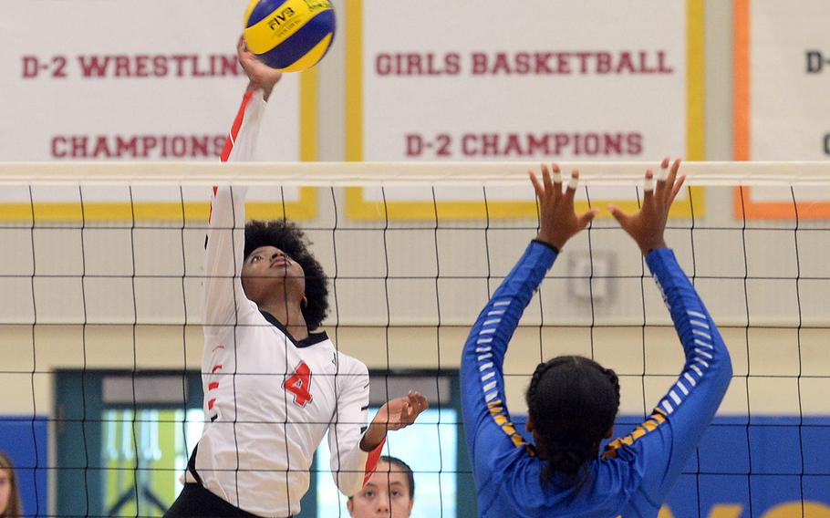 E.J. King's Liz Turner spikes against Yokota's Trinity Stegall during Saturday's DODEA-Japan volleyball match. The Cobras won in three sets to sweep the two-match weekend set against the Panthers.