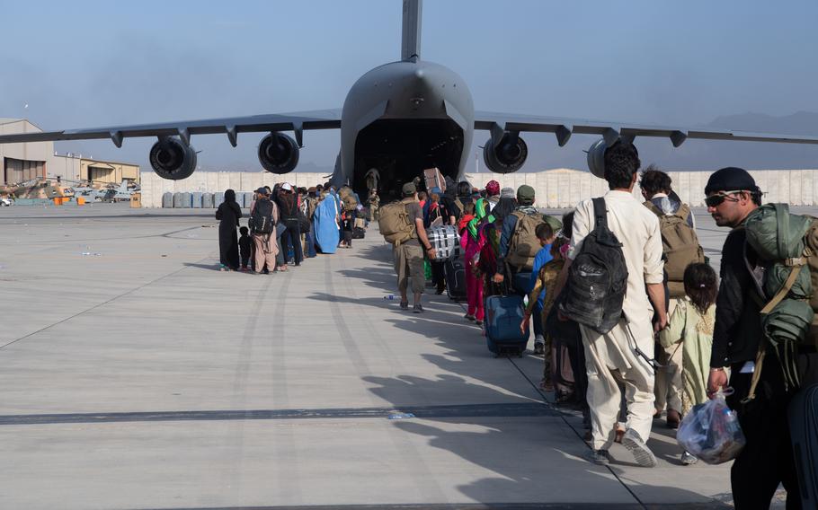 Air Force loadmasters and pilots assigned to the 816th Expeditionary Airlift Squadron load passengers aboard an Air Force C-17 Globemaster III in support of the Afghanistan evacuation at Hamid Karzai International Airport in Kabul on Aug. 24, 2021. 