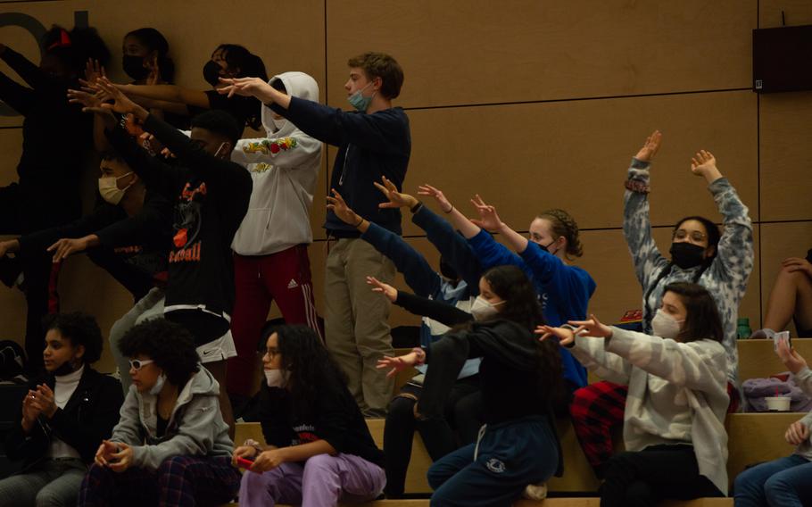 Spectating students cheer on their team during a free throw at the DODEA-Europe Division III boys basketball title game in Kaiserslautern, Germany, on Saturday, Feb. 26, 2022.