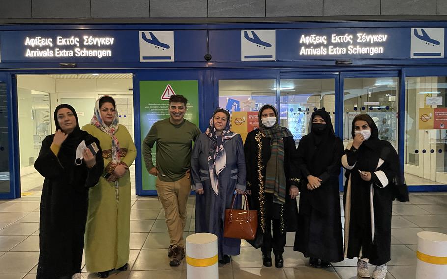 Amed Khan, a New York-based philanthropist, center, stands in Athens airport with female lawmakers he helped escape Afghanistan.