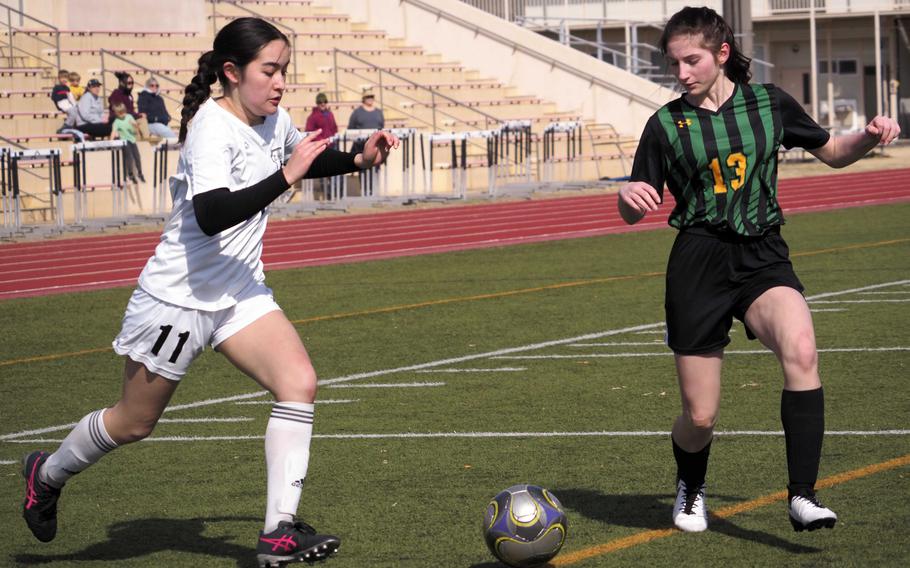 Zama‘s Lindsey So dribbles against Robert D. Edgren’s Amy Beck during Saturday’s DODEA-Japan girls soccer match. The Trojans won 2-1 to sweep the weekend series.