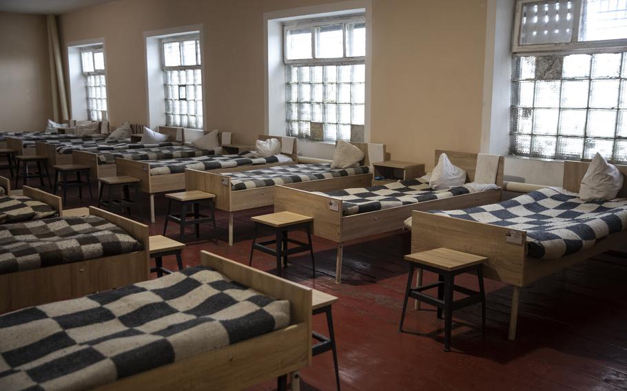 One of the many sleeping rooms where detained male Russian prisoners of war sleep at a detention camp in western Ukraine.