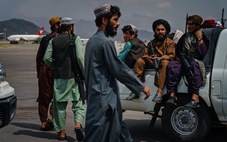 Taliban fighters patrol the tarmac after the United States Military have completely withdrawn from the country and Taliban fighters moved in to take control of Hamid Karzai International Airport, in Kabul, Afghanistan, Aug. 31, 2021.