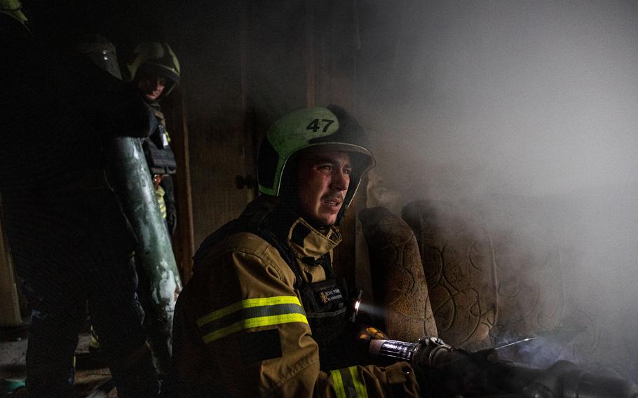 Ukraine firefighters put out a fire in a residential building following a shelling on the frontline town of Bakhmut, in eastern Ukraine’s Donetsk region, on Oct. 29, 2022, amid Russia’s military invasion. 