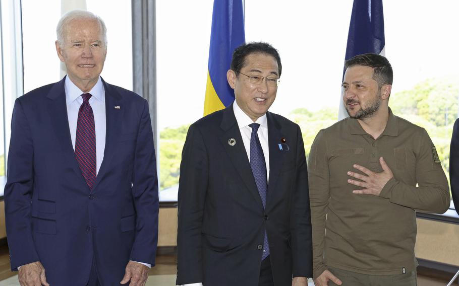 Ukrainian President Volodymyr Zelenskyy, right, Japan’s Prime Minister Fumio Kishida, center, and U.S. President Joe Biden, pose for a photo with other G7 leaders before a working session on Ukraine during the G7 Summit in Hiroshima, western Japan, Sunday, May 21, 2023. 