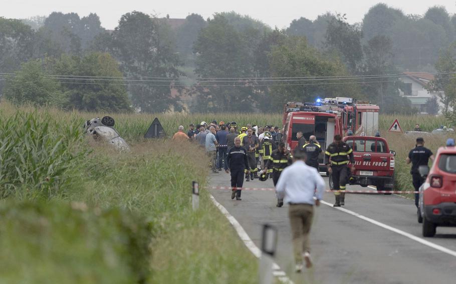 The debris of a burnt car is seen at left as firefighters seal off the area where an aircraft of the Italian acrobatic air team the Frecce Tricolori crashed during a practice run outside the northern city of Turin, Italy, Saturday, Sept. 16, 2023.