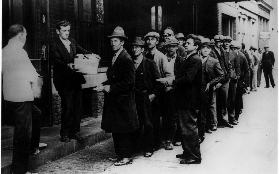 A long line of people waiting to be fed in New York City during the Great Depression. 