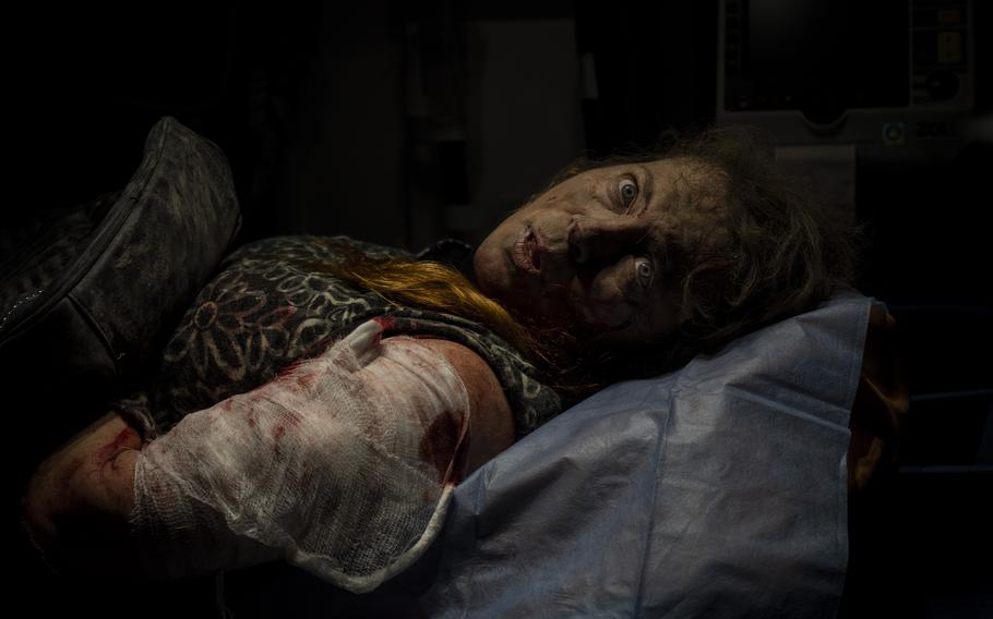 A resident wounded after a Russian attack lies inside an ambulance before being taken to a hospital in Kherson, southern Ukraine, Thursday, Nov. 24, 2022. 